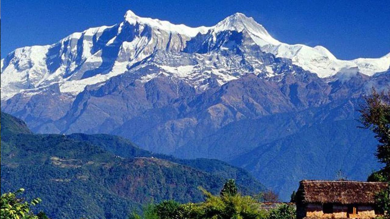 Snow-capped Annapurna peaks behind Sirubari village.