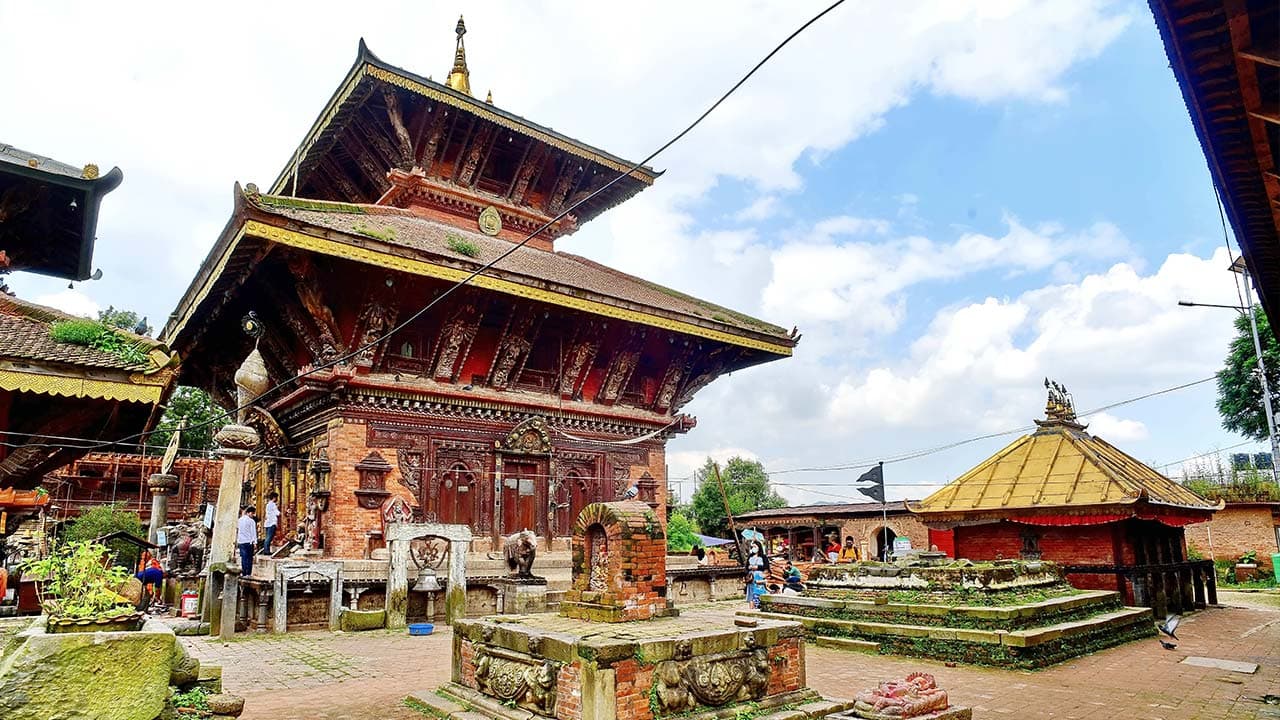 Historic wooden pagoda architecture and stone courtyards at Changunarayan Temple in Nepal.