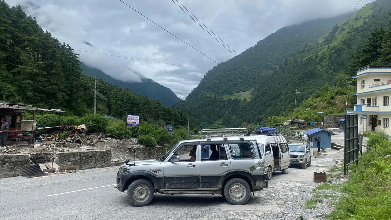 Silver 4WD jeep parked on a scenic mountain highway during the Upper Mustang Jeep Tour.