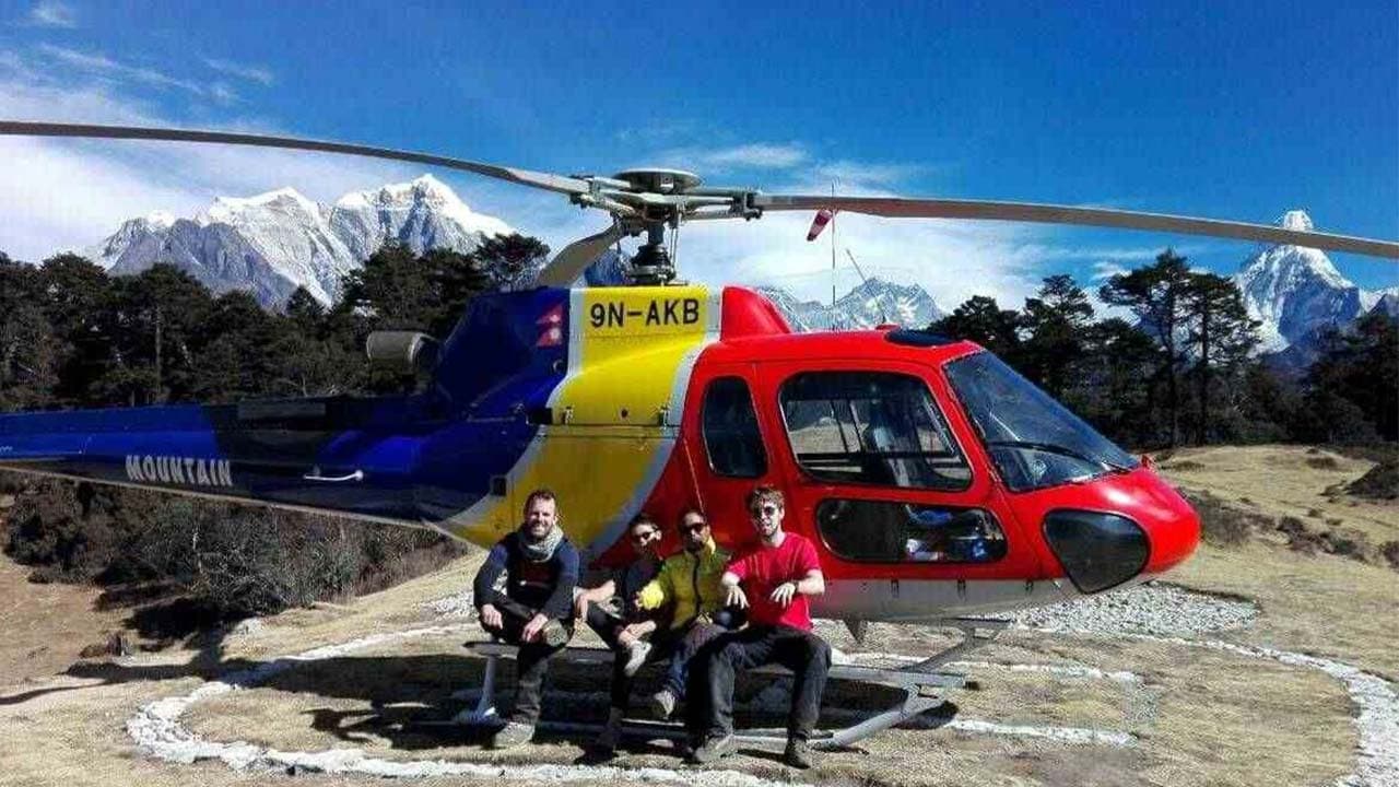 Group by a helicopter on an Everest Base Camp tour.