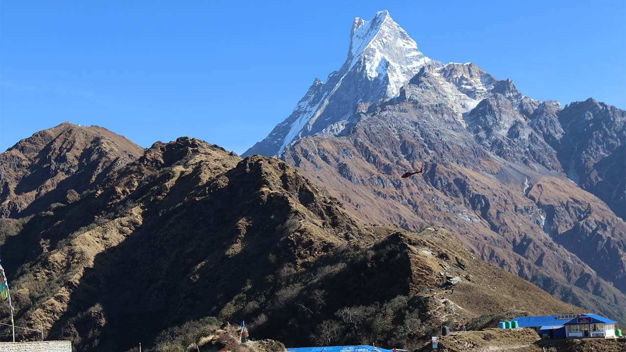 Mount Machhapuchhre peak towering over rocky Himalayan ridges on the Mardi Himal trek.